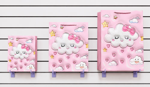 Bolsas de regalo modelo 3279 con nubes sonrientes, arcoíris y colores pastel. Disponibles en tamaños chica, mediana y grande. Importación directa ROGLUX.